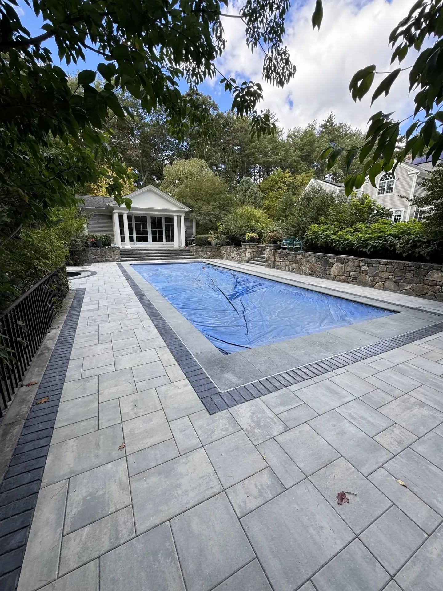 Large-format paver pool deck with a charcoal border in Acton, MA