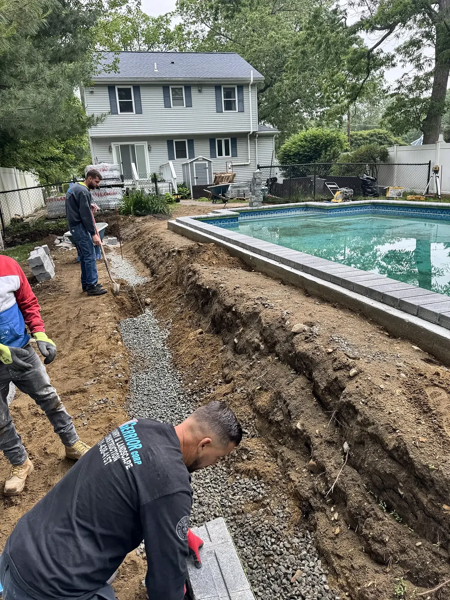 Crew installing a new paver pool deck in Billerica, MA