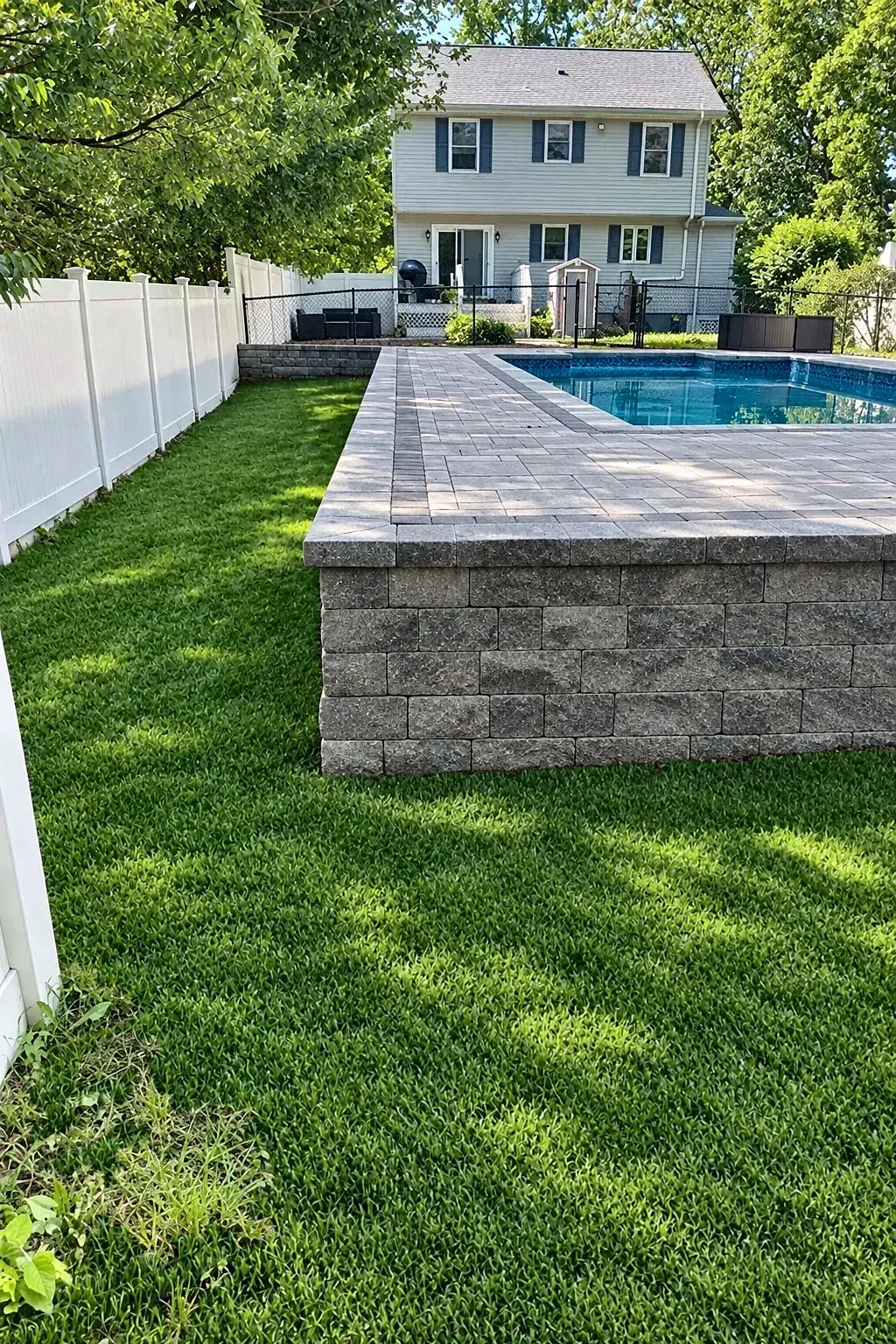 Raised side of the pool deck with a block face